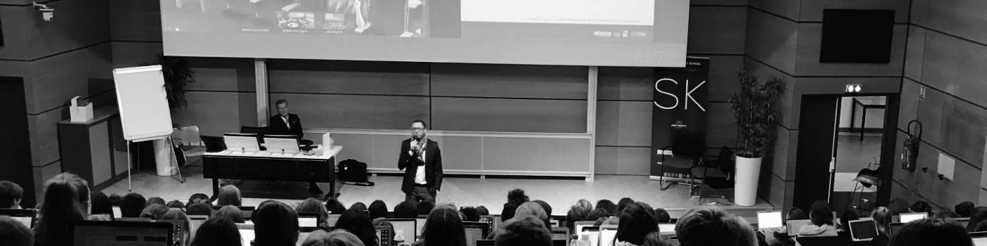 Jean-Francois Detout presents in front of students in a large lecture hall